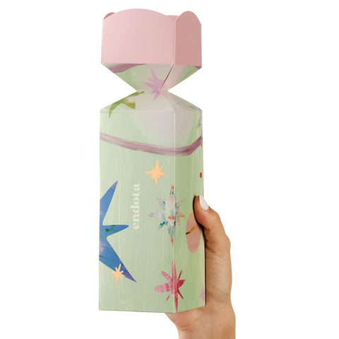 Hand holding a colorful Hydrating Duo Bon Bon product box with 'endota' branding.