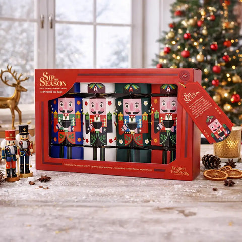 A boxed set of four Christmas nutcracker-shaped bottles from English Tea Shop, displayed in a red gift box.