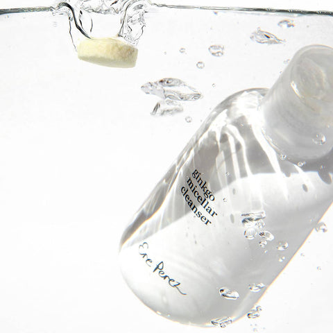 Clear bottle of Ere Perez ginkgo micellar cleanser 37g bottle with a droplet of liquid being poured into water.