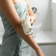 Person using the sisal body cloth on her arms.