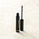 Medium Brown Brow wand on a stone surface.