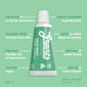 Green travel-size tube of Grants toothpaste on a green background with text highlighting its benefits.