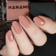 Nail polish with 'HANAMI' branding and matching nail color on a hand.