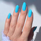 Hand with blue nail polish on a light background