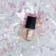 Holograms nail polish with black cap on a glittery, iridescent background