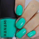 Turquoise nails with a bottle of HANAMI nail polish