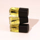 Three bottles of Hanami nail polish with black caps on a light pink background