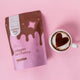 Happy Way Collagen Hot Choccy package with a cup of hot chocolate on a pink background.