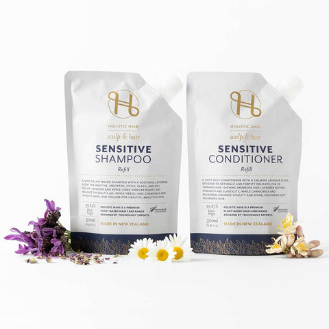 Sensitive shampoo & conditioner refill pouches on a white background with chamomile & lavender flowers.