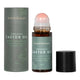 Honest Skincare Organic Castor Oil Rose Quartz Roller 50ml bottle with its roller ball showing, standing beside its grey cylinder box on white