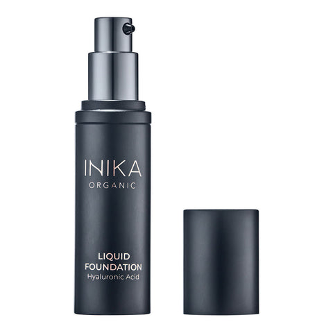 Black pump bottle of INIKA Organic Liquid Foundation with the cap off.