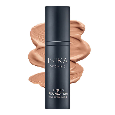 Bottle of INIKA Organic Liquid Foundation with a tan-coloured swatch behind it.