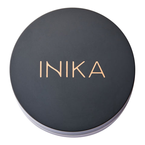 INIKA branding on a black round container lid.