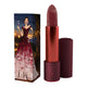 Lipstick next to box packaging that pictures a woman drinking red wine with a gown of the same colour. Red lipstick case with flower detail on lid. 