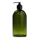 Green glass bottle with black pump dispenser on a white background