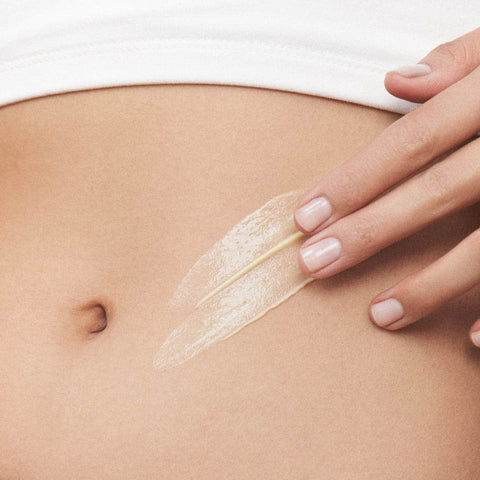 Swatch of hand & body lotion on a model's stomach.