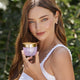 Miranda Kerr holding Plant Stem Cell Retinol Alternative Moisturizer 50ml jar.