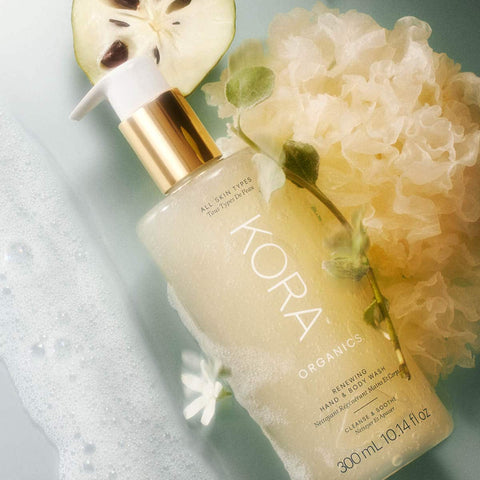 Kora Organics hand and body wash with a floral and natural elements on a light background.