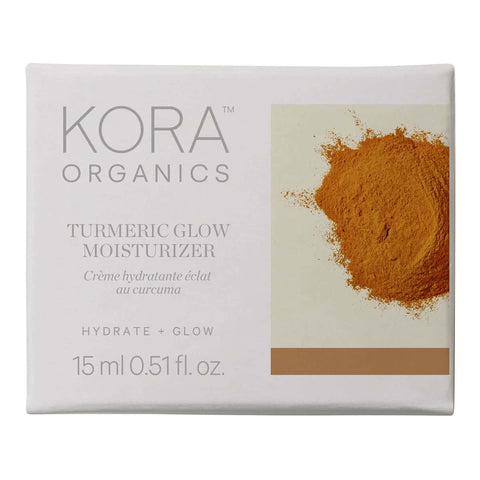 Kora Organics Turmeric Glow Moisturizer packaging with turmeric powder on a white background.