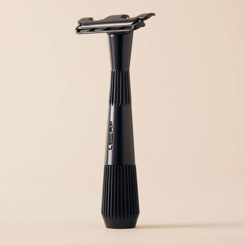 Black razor on a beige background