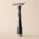 Silver safety razor on a beige background