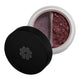 Makeup product with black lid and open container showing purple powder