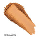 Cinnamon-colored makeup swatch on a white background