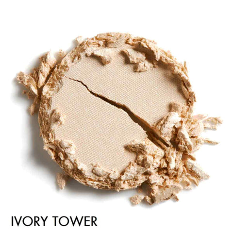 Crumbled makeup swatch in the shade 'Ivory Tower' - a creamy nude on a white background.