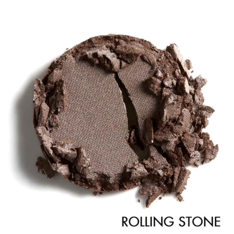Brown pressed eyeshadow showing texture on a white background, labeled 'Rolling Stone'.