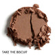 Brown pressed eye shadow on a white background, in the shade - 'Take the Biscuit'.