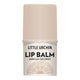 A vanilla coconut flavored lip balm stick by Little Urchin, featuring a light beige cap and a white label with black text and a subtle beige graphic at the bottom.