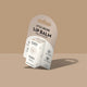 A small white lip balm package on a hanger card photographed against a warm beige background with a soft shadow.