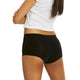 Person wearing black underwear and a white top on a white background