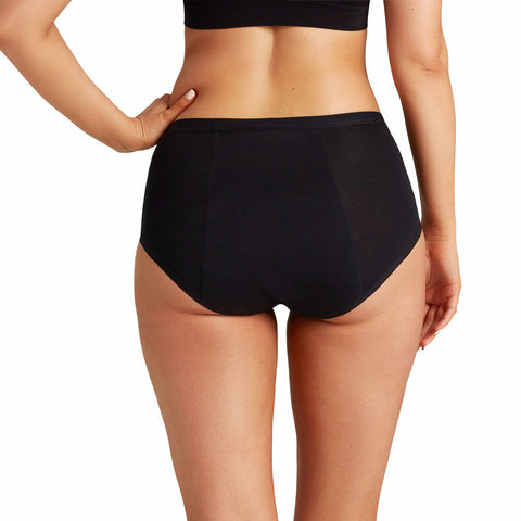 Person wearing black high-waisted underwear on a white background