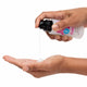 Hand holding a bottle of lubricant over another hand on a white background