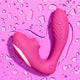 Pink vibrator on a pink background with water droplets.