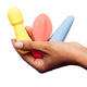 Hand holding three colourful silicone mini vibrators.