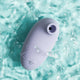 Purple air suction stimulator in water with blue background. 