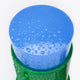 A close-up of a blue serum stick, covered in water droplets and sitting in a green container.