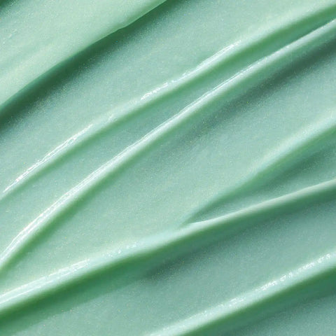 Close-up of light green serum with visible texture.