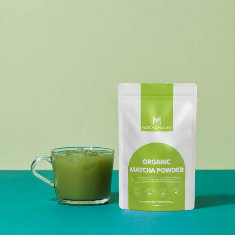 Matcha tart on a white plate with Matcha Maiden packaging on a light background