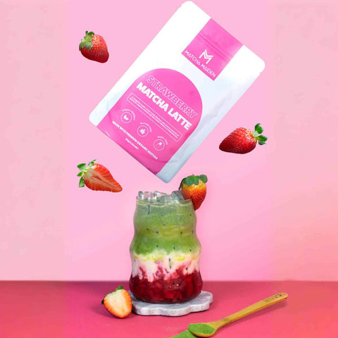 Strawberry Matcha Latte with a package of strawberry matcha latte on a pink background
