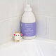 Moogoo Baby & Child bubbly wash bottle on a tiled bathroom shelf with a cow-shaped toy.