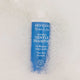 Blue bottle of Moogoo Baby & Child Gentle Shampoo in a bubble bath.