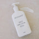 MUDGANICS body lotion bottle on a beige background next to a swatch.