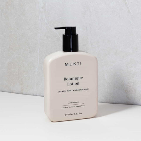 Mukti Botanique Lotion bottle on a light gray background.