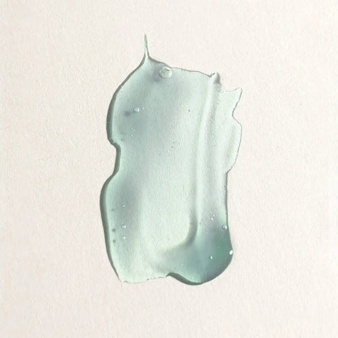 Swatch of blue gel-like hyaluronic marine serum on a neutral background.