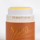 Nada Organics tallow balm with lid off showing yellow balm with gold text on a white background