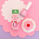 Nail polish styled on a pink, white and purple background with a toy cupcake. 