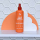 Orange hair detangler bottle with brand name on a white & orange geometric background.